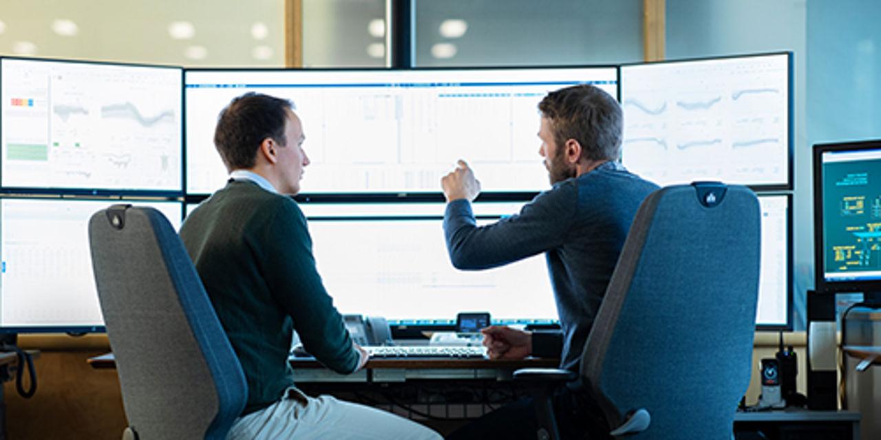 Two men looking at screen discussing PPAs