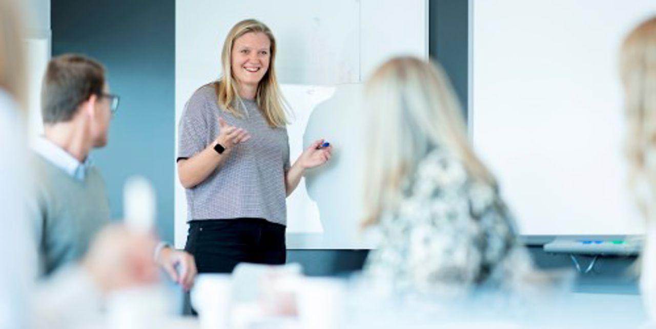 Trainee talking to group of people